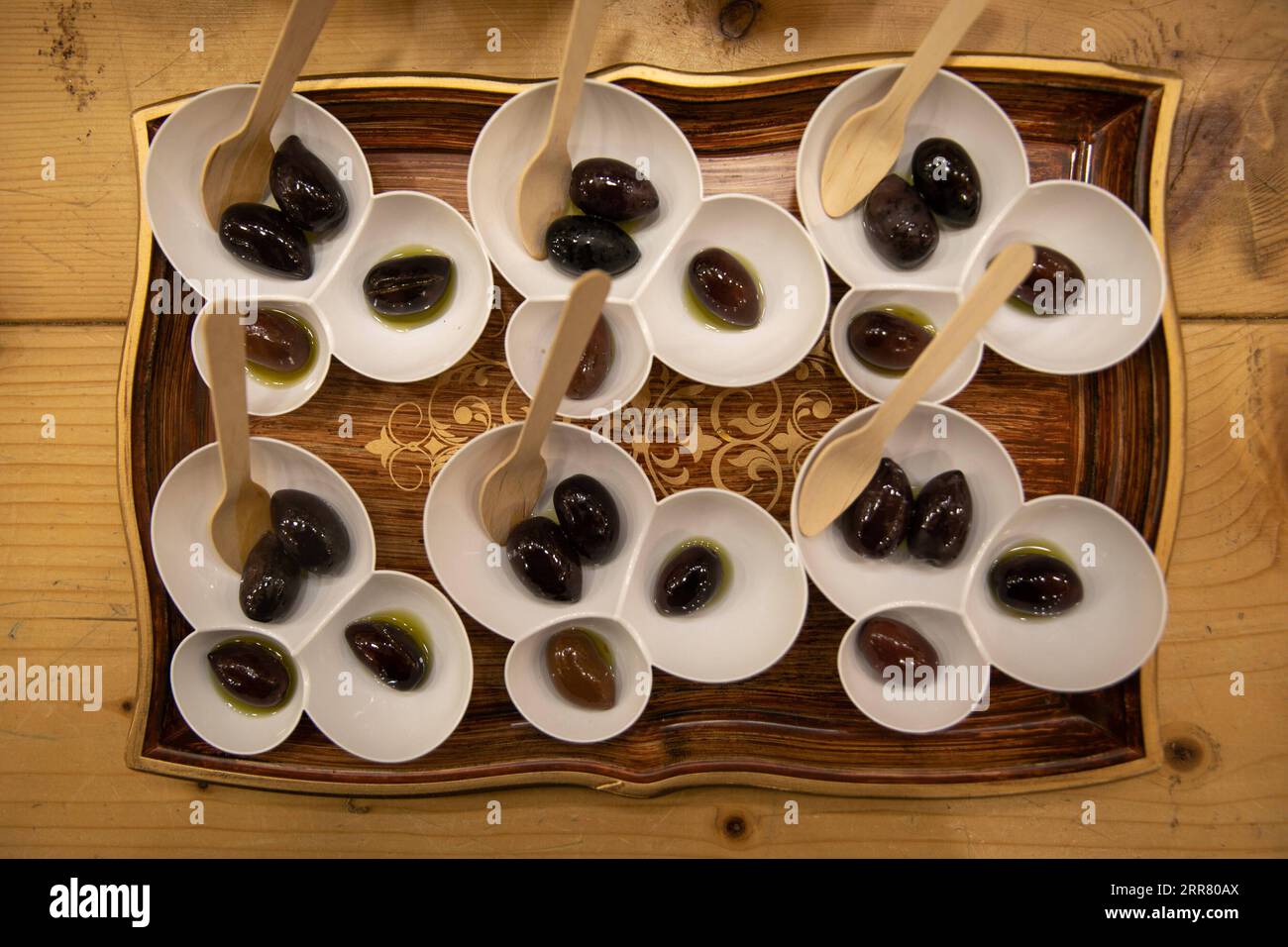 210410 -- KALAMATA, April 10, 2021 -- Photo taken on April 1, 2021 shows a traditional serving of Kalamata olives preserved in olive oil and brine in Kalamata, Greece. Known as the black queen of all Greek olives, the Kalamata, grown in the sun-kissed olive groves around Messinia in the southwestern part of the Peloponnese and named after the capital city of the region, has been an integral part of the local gastronomy and economy for centuries. TO GO WITH Feature: Producers of Greece s Kalamata olives seek to conquer China as next big market Photo by /Xinhua GREECE-KALAMATA-OLIVE LefterisxPar Stock Photo