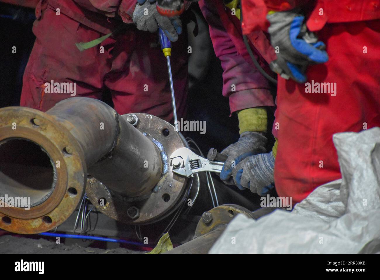 210411 -- URUMQI, April 11, 2021 -- Rescuers work at a flooded coal mine in Hutubi County of Hui Autonomous Prefecture of Changji, northwest China s Xinjiang Uygur Autonomous Region, April 11, 2021. Eight people have been rescued and 21 still trapped after a coal mine was flooded Saturday in Xinjiang, local authorities said Sunday. The accident occurred around 6:10 p.m. Saturday, when 29 workers were upgrading the coal mine. Rescue work is currently underway.  SPOT NEWSCHINA-XINJIANG-COAL MINE ACCIDENT-RESCUE CN GaoxHan PUBLICATIONxNOTxINxCHN Stock Photo