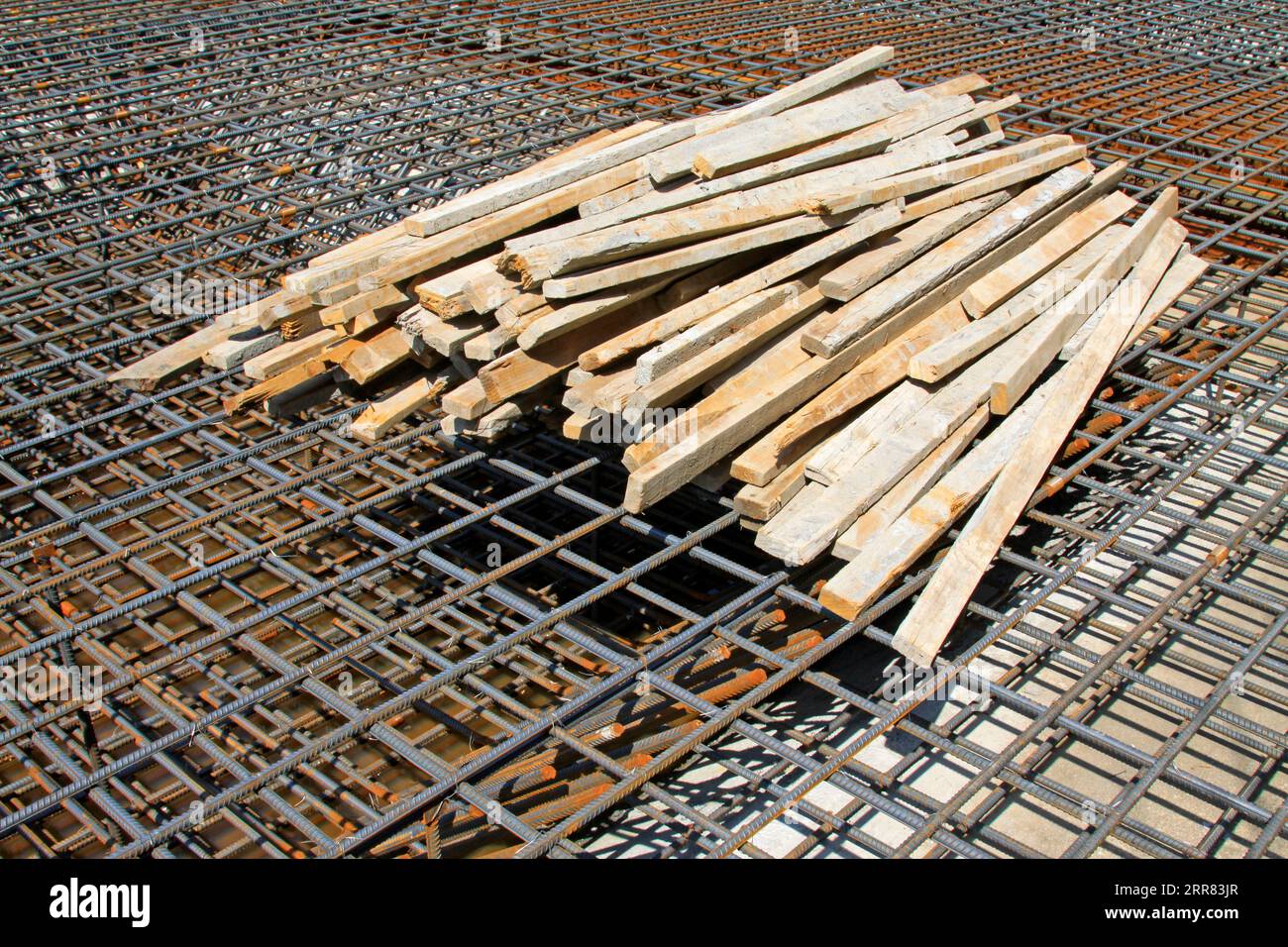 twisted steel frame and wood, in the construction site Stock Photo - Alamy