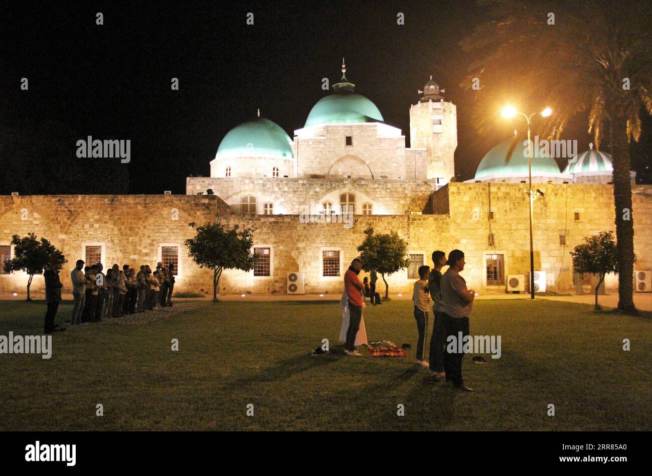 210418 -- TRIPOLI LEBANON, April 18, 2021 -- People perform evening prayers during the Islamic holy month of Ramadan outside a mosque in Tripoli, Lebanon, on April 18, 2021. Photo by /Xinhua LEBANON-TRIPOLI-RAMADAN Khaled PUBLICATIONxNOTxINxCHN Stock Photo