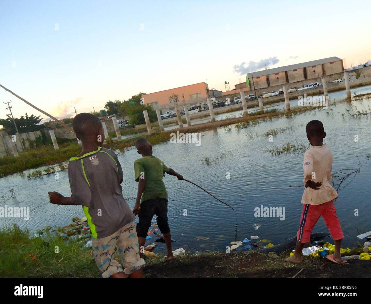 210419 -- LUSAKA, April 19, 2021 -- Paul Mkandawire R and his friends fish at a popular dam in Misisi compound, a slum in Zambia s capital Lusaka on April 12, 2021. Photo by /Xinhua TO GO WITH Feature: Slum children in Zambia help supplement household food supplies ZAMBIA-LUSAKA-SLUM CHILDREN-FISHING LillianxBanda PUBLICATIONxNOTxINxCHN Stock Photo