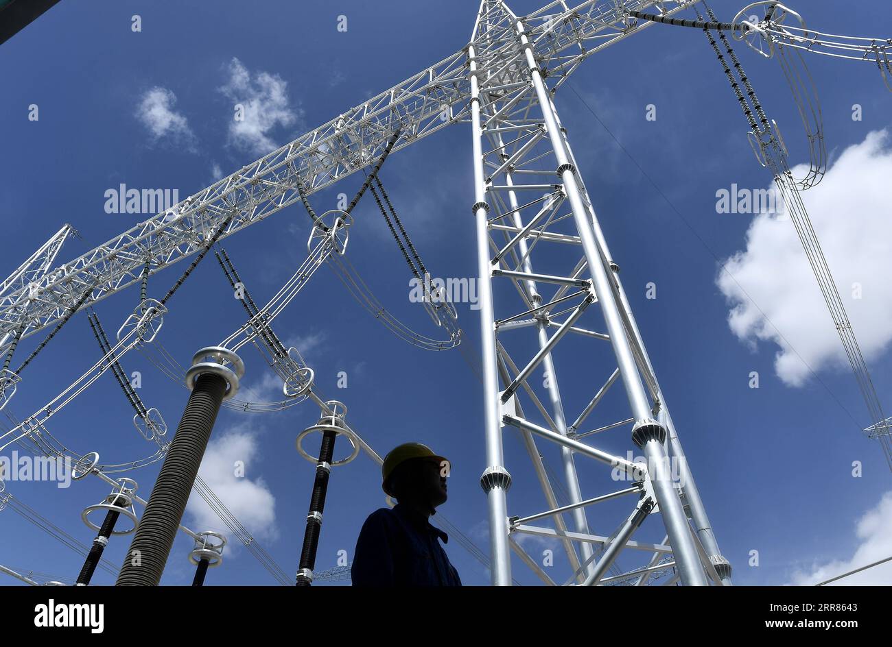 210420 -- XINING, April 20, 2021 -- A worker patrols at a converter station of ultra-high voltage transmission line from Qinghai to Henan, in northwest China s Qinghai Province, April 16, 2021. The clean power transmission volume of ultra-high voltage link between Qinghai and Henan has hit 10 billion kilowatt-hours kWh, according to State Grid Corporation of China SGCC. The 800-kilovolt direct current transmission line, stretching 1563 kilometers via four provinces, from northwest China s Qinghai, Gansu and Shaanxi provinces to central China s Henan Province, started its operation on December Stock Photo