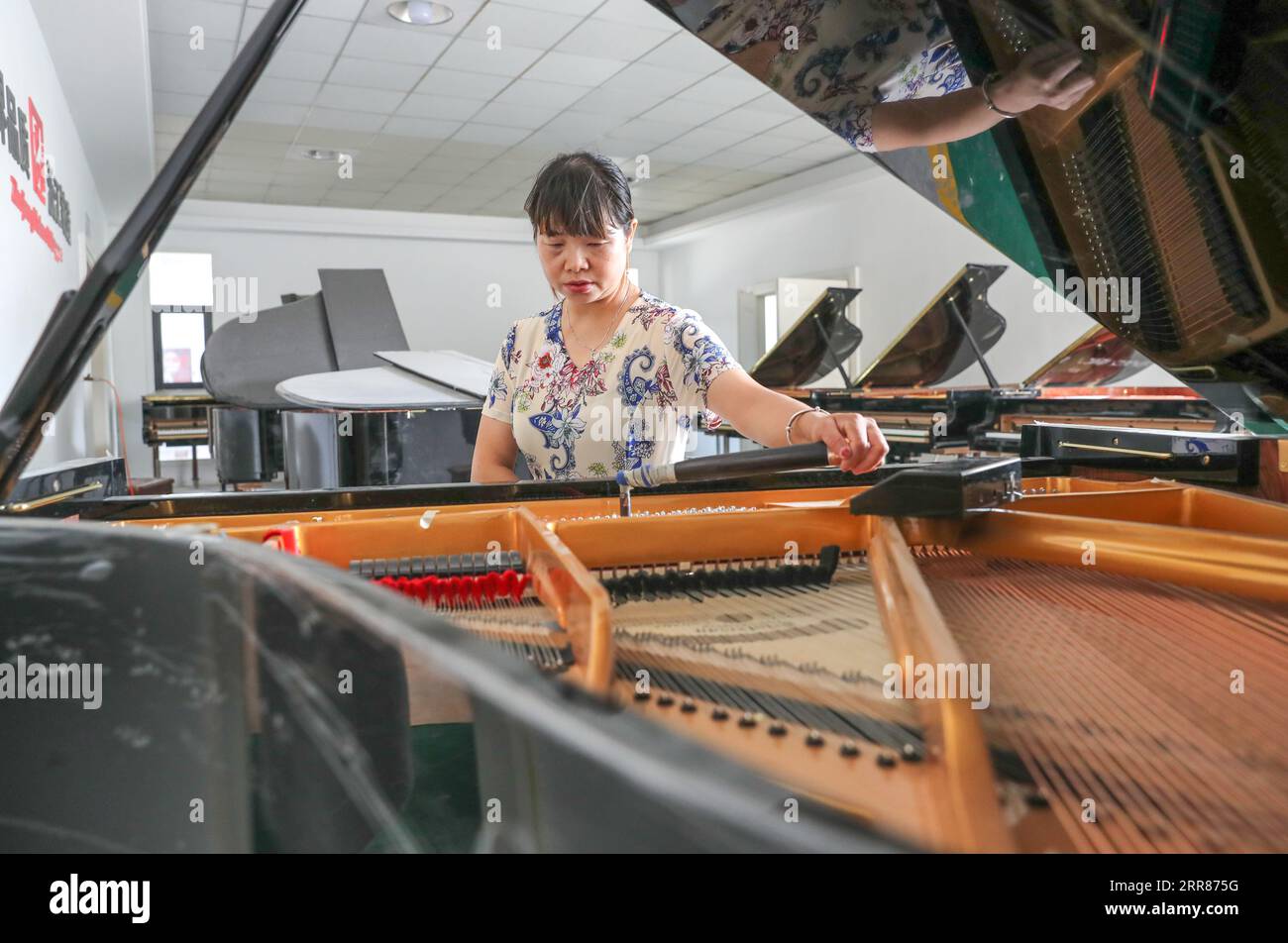 HUZHOU, CHINA - SEPTEMBER 7, 2023 - A technician adjusts the timbre of a piano in Huzhou, Zhejiang province, China, Sept 7, 2023. Stock Photo