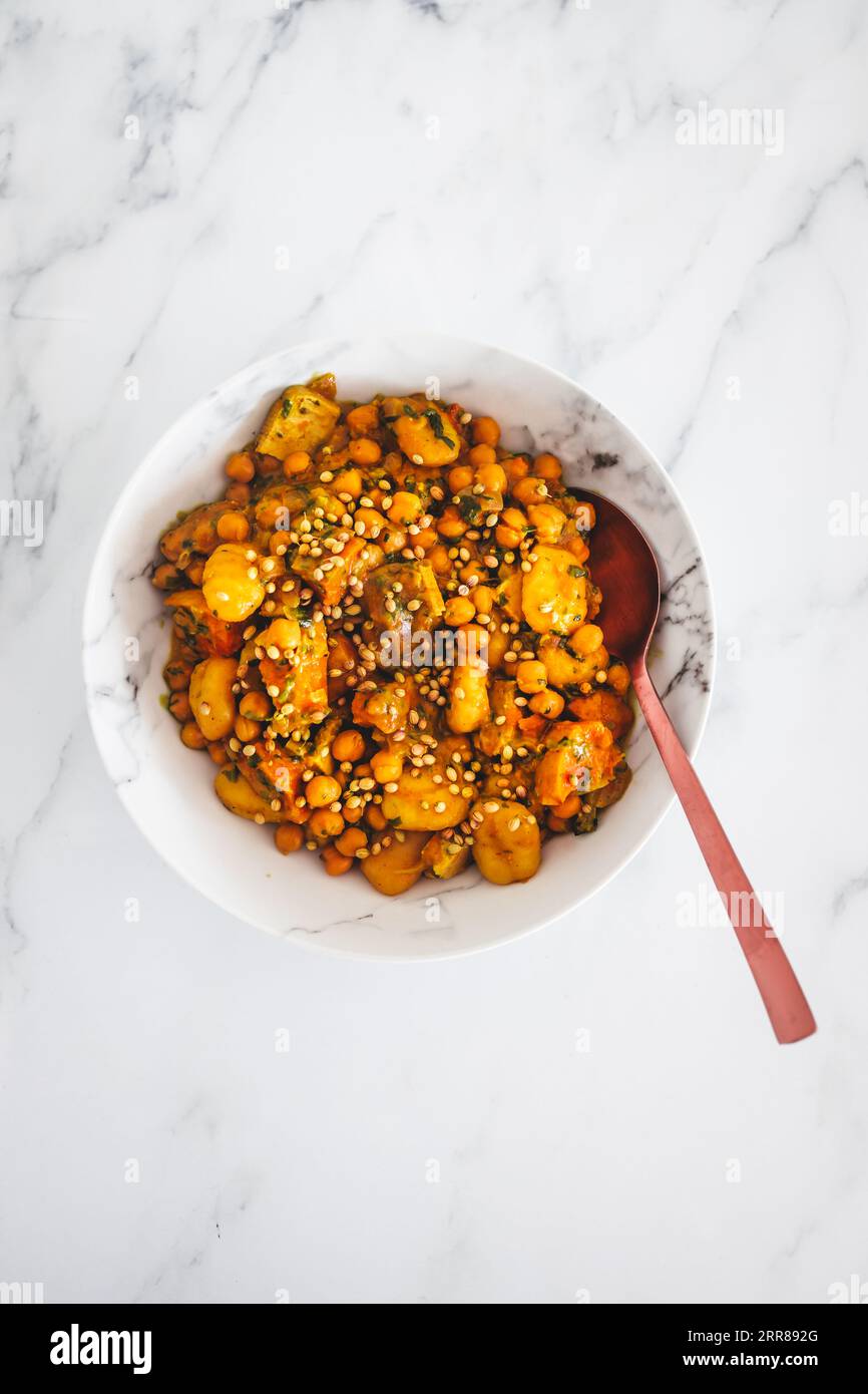 plant-based potato gnocchi with roasted pumpkin and chickpeas, healthy vegan food recipes Stock Photo