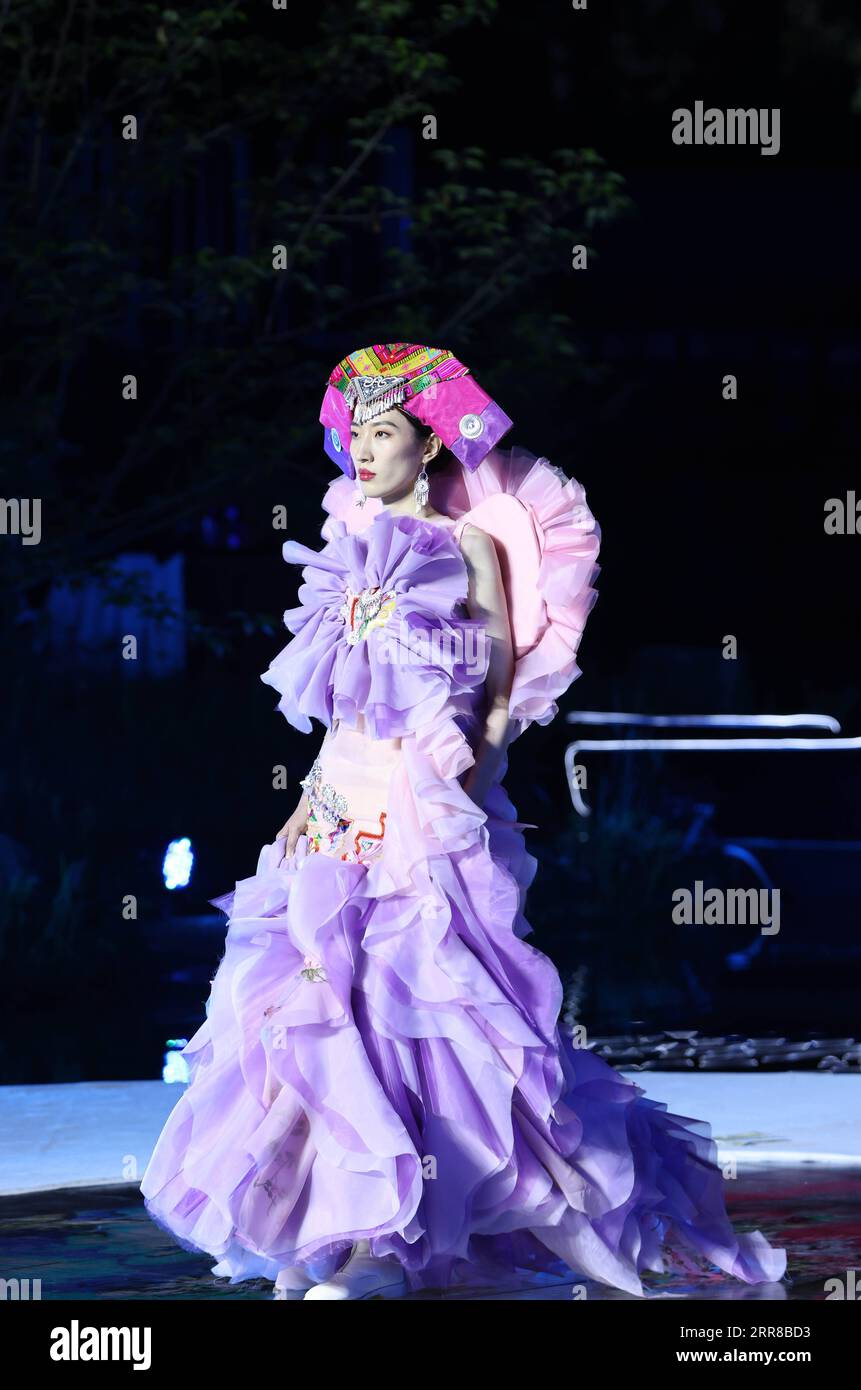 210429 -- TONGLU, April 29, 2021 -- A model presents a creation during a design exhibition featuring indigenous style in Eshan Ethnic Village of Tonglu County, east China s Zhejiang Province, April 28, 2021.  CHINA-ZHEJIANG-TONGLU-DESIGN EXHIBITION CN ChenxJianli PUBLICATIONxNOTxINxCHN Stock Photo