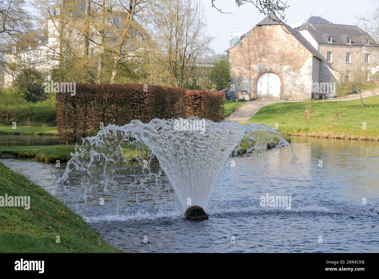210501 -- NAMUR, May 1, 2021 -- A pond and a fountain are seen in the Water Gardens of Annevoie in Annevoie-Rouillon, Namur, Belgium, May 1, 2021. The Water Gardens of Annevoie were designed and built by Charles-Alexis de Montpellier in the 18th century, with the combination of three ideas: art enhancing nature , art in tune with nature and art imitating nature . In 1930 the Gardens were opened for the general public. In 1982, the entire estate, including the gardens and the buildings, were listed as Historical Monuments.  BELGIUM-NAMUR-WATER GARDENS OF ANNEVOIE-SCENERY ZhengxHuansong PUBLICAT Stock Photo