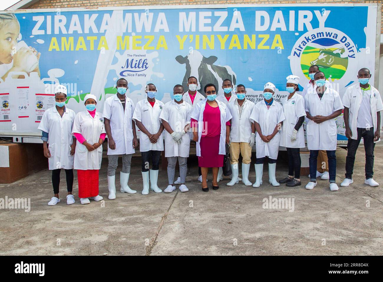 210502 -- NYANZA, May 2, 2021 -- Immaculee Kayitesi C, owner of Zirakamwa Meza Dairy, poses for a group photo with employees of her company in Nyanza district, about a two-hour drive from the Rwandan capital city Kigali, on April 30, 2021. TO GO WITH Feature: From genocide widow to successful businesswoman -- Rwandan woman walking out of shadow photo by /Xinhua RWANDA-NYANZA-GENOCIDE-BUSINESS WOMAN CyrilxNdegeya PUBLICATIONxNOTxINxCHN Stock Photo