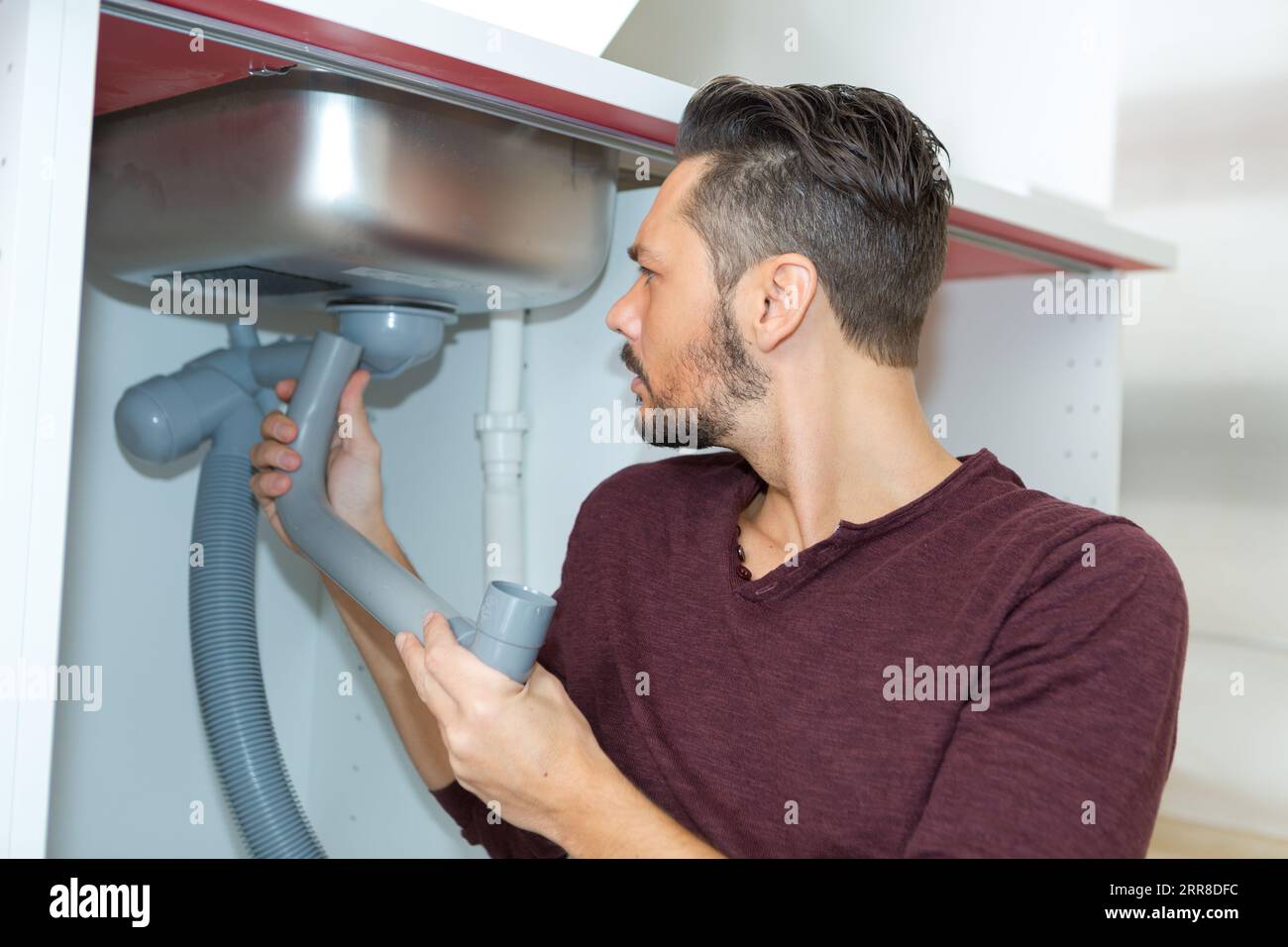 replacing plumbing pipes under the sink Stock Photo Alamy