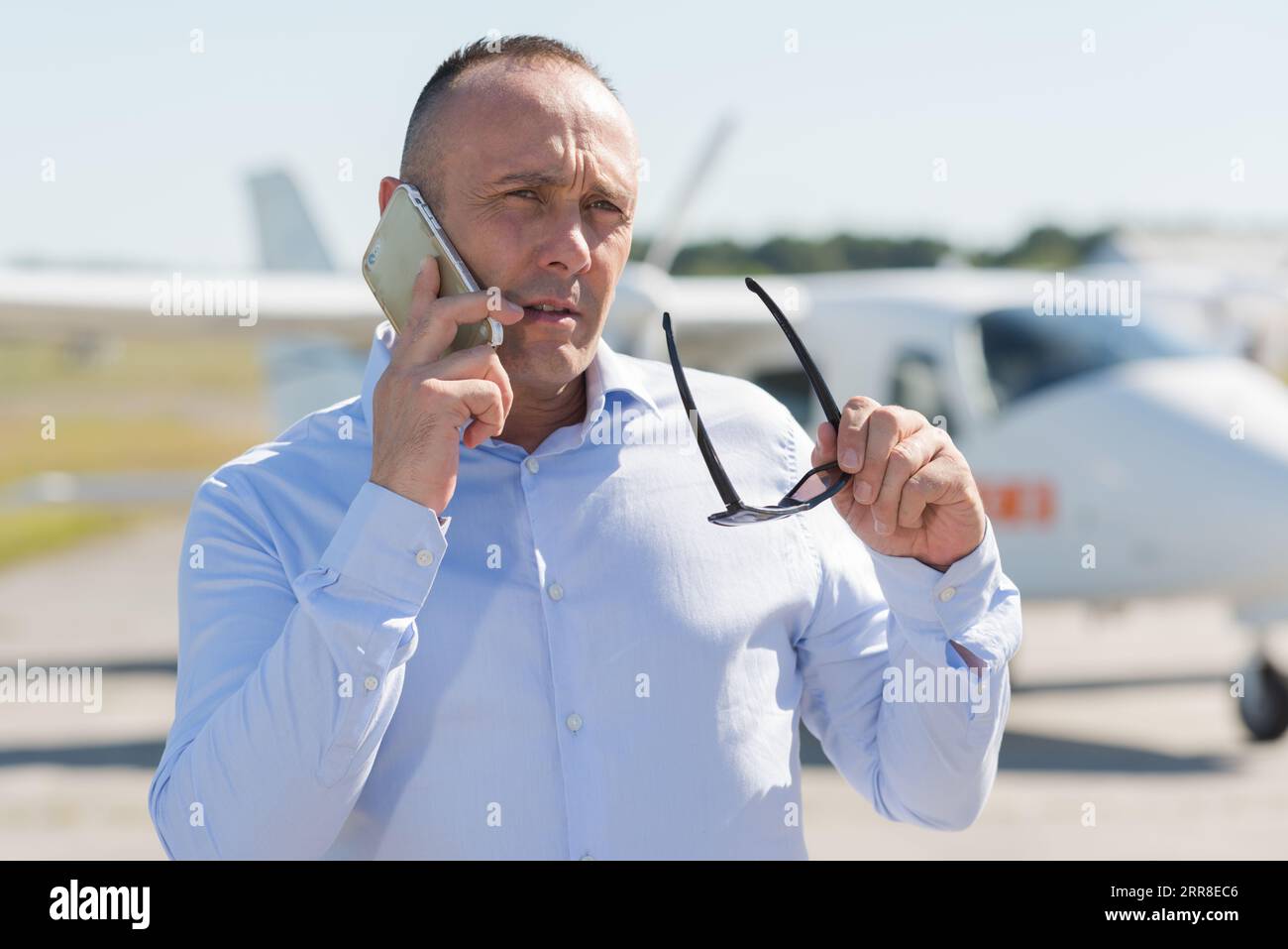 portrait of smiling businessman on call Stock Photo