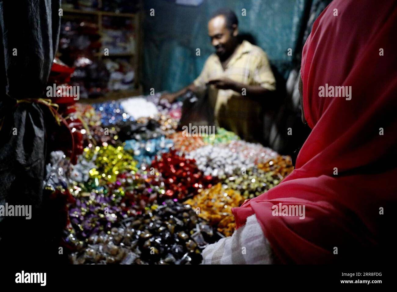 210506 -- KHARTOUM, May 6, 2021 -- A vendor sells sweets at a market in Khartoum, Sudan, May 5, 2021. Eid Al-Fitr, also called the festival of breaking the fast that marks the end of the month-long dawn-to-sunset fasting of Ramadan, is celebrated by Muslims worldwide.  SUDAN-KHARTOUM-EID AL-FITR-SHOPPING MohamedxKhidir PUBLICATIONxNOTxINxCHN Stock Photo
