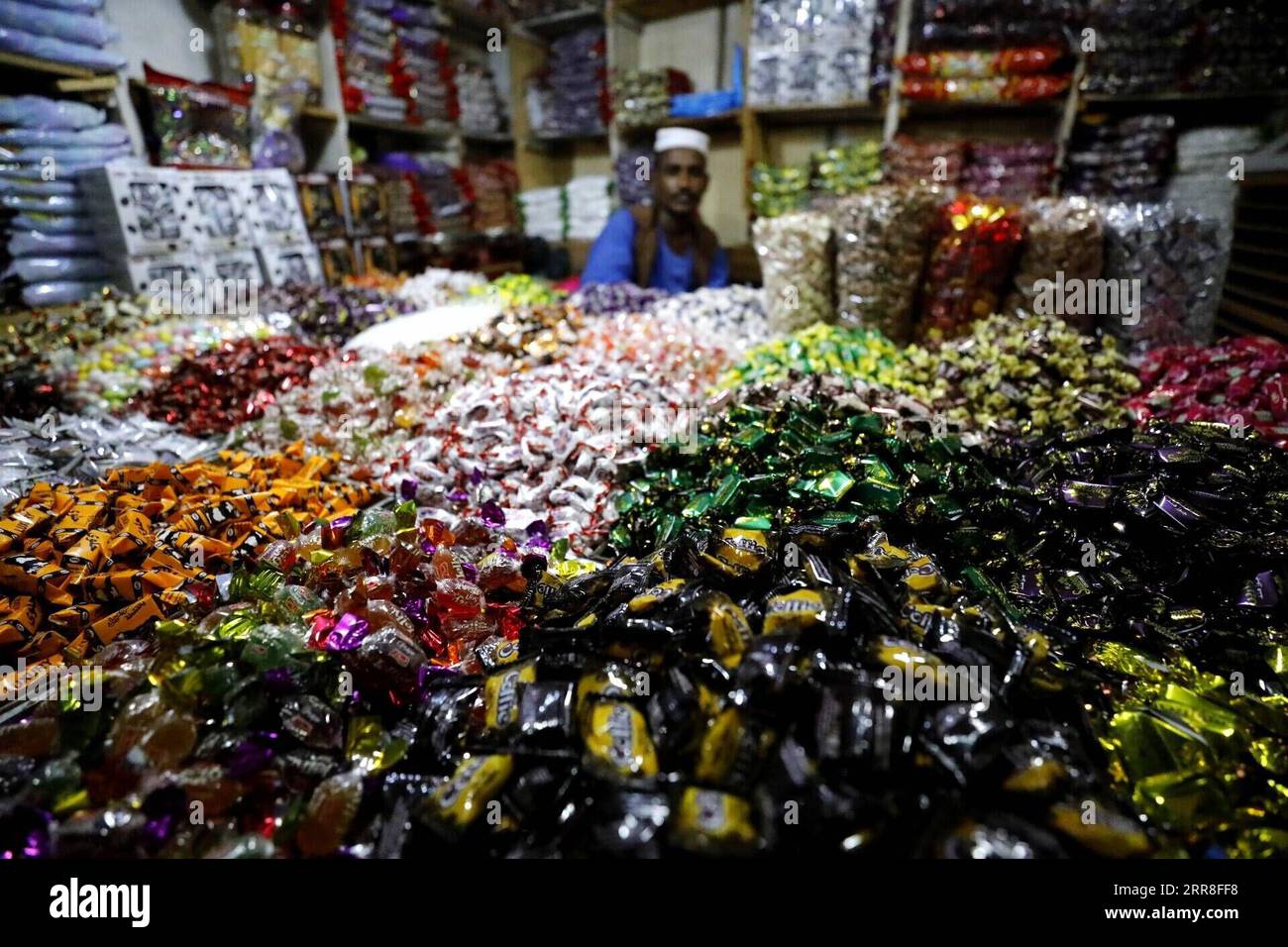 210506 -- KHARTOUM, May 6, 2021 -- A vendor sells sweets at a market in Khartoum, Sudan, May 5, 2021. Eid Al-Fitr, also called the festival of breaking the fast that marks the end of the month-long dawn-to-sunset fasting of Ramadan, is celebrated by Muslims worldwide.  SUDAN-KHARTOUM-EID AL-FITR-SHOPPING MohamedxKhidir PUBLICATIONxNOTxINxCHN Stock Photo
