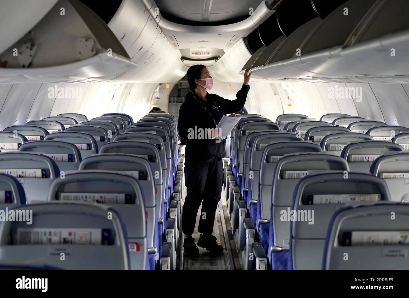 210510 -- ZHENGZHOU, May 10, 2021 -- Liu Qiqi checks luggage rack of an airplane at a maintenance base of the Henan branch of China Southern Airlines in Zhengzhou, central China s Henan Province, April 30, 2021. Liu Qiqi is a 24-year-old mechanic in Henan branch of China Southern Airlines. Graduating from Civil Aviation University of China in 2019, Liu Qiqi is eye-catching in the team, for she is the only female mechanic in the nearly 200-strong maintenance workforce. Working in a traditionally male-dominated industry, Liu was questioned a lot when she entered the profession. The job requires Stock Photo