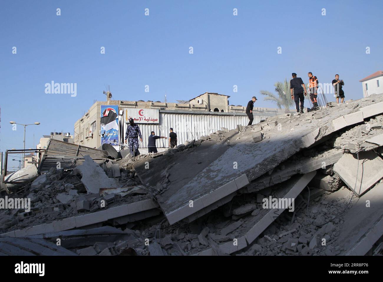 210514 -- GAZA, May 14, 2021 -- Palestinian people inspect the remains of a bank destroyed by an Israeli air strike in Gaza City, on May 14, 2021. Israel on Friday evening bombarded a bank that belongs to Hamas in Gaza city, the Israeli military and Hamas said. Photo by /Xinhua MIDEAST-GAZA CITY-HAMAS BANK-ISRAEL-AIR STRIKES RizekxAbdeljawad PUBLICATIONxNOTxINxCHN Stock Photo