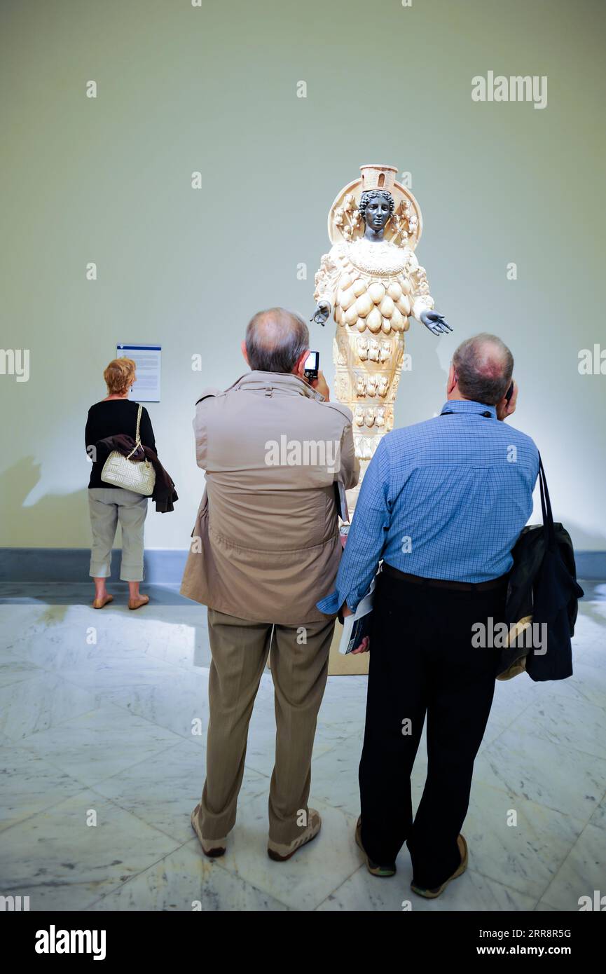 Naples, Italy, Tourists observing a Marble statue at a museum Stock Photo