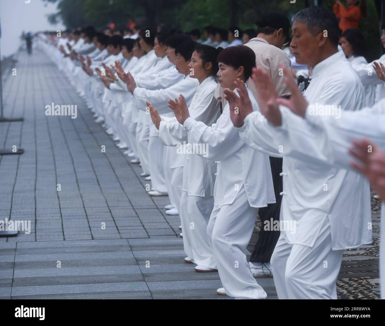 210519 -- TONGLU, May 19, 2021 -- Senior hobbyists of Taijiquan, a traditional Chinese martial art, demonstrate Taijiquan moves by Fuchunjiang River in Tonglu County, east China s Zhejiang Province, on May 19, 2021. A nation-wide campaign to promote and demonstrate Taijiquan as a fitness exercise among senior citizens was launched here on Wednesday. More than 2,000 Taijiquan hobbyists from all over the country flocked in to participate in the demonstrations and performances.  CHINA-ZHEJIANG-TONGLU-TAIJIQUAN FITNESS EXERCISESCN XuxYu PUBLICATIONxNOTxINxCHN Stock Photo