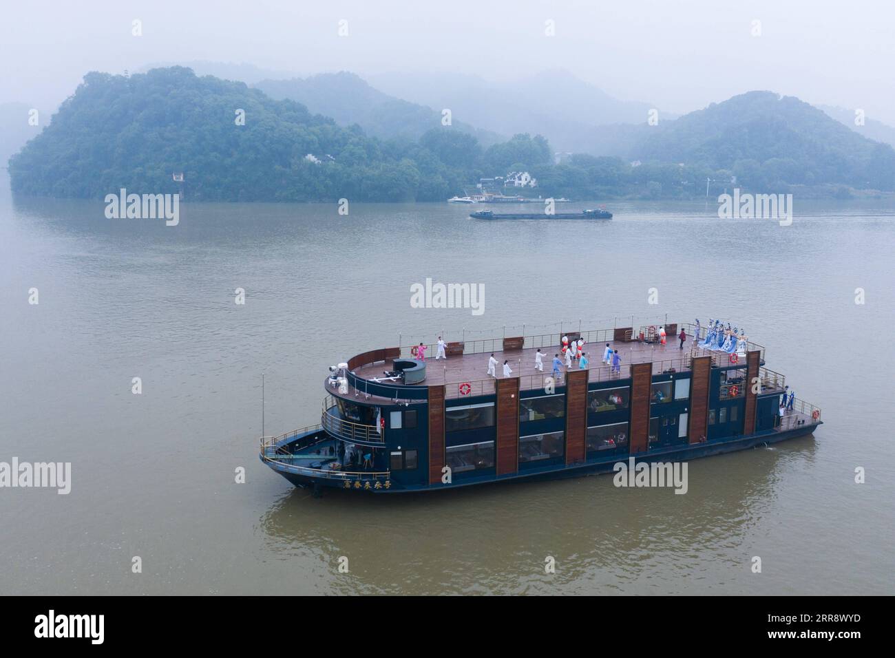 210519 -- TONGLU, May 19, 2021 -- Aerial photo taken on May 19, 2021 shows senior hobbyists of Taijiquan, a traditional Chinese martial art, demonstrating Taijiquan moves on a boat in Fuchunjiang River in Tonglu County, east China s Zhejiang Province. A nation-wide campaign to promote and demonstrate Taijiquan as a fitness exercise among senior citizens was launched here on Wednesday. More than 2,000 Taijiquan hobbyists from all over the country flocked in to participate in the demonstrations and performances.  CHINA-ZHEJIANG-TONGLU-TAIJIQUAN FITNESS EXERCISESCN XuxYu PUBLICATIONxNOTxINxCHN Stock Photo