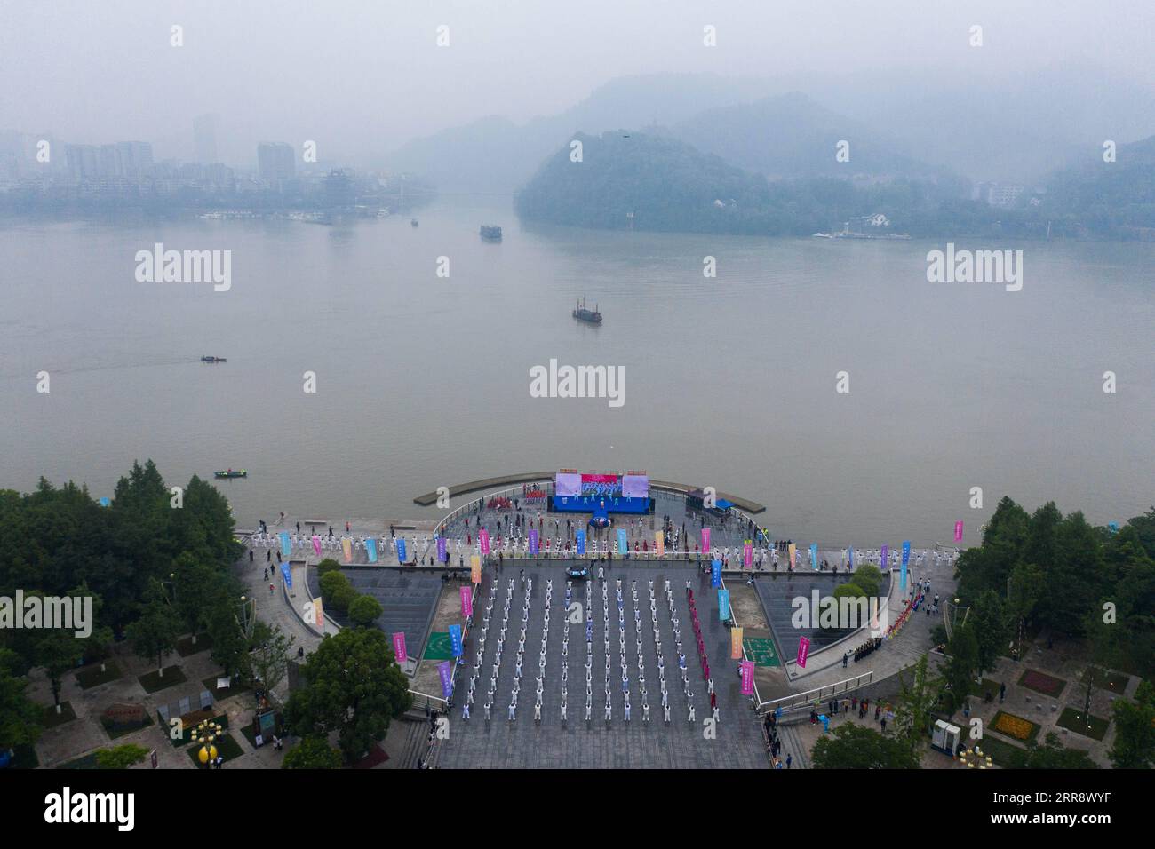 210519 -- TONGLU, May 19, 2021 -- Aerial photo taken on May 19, 2021 shows senior hobbyists of Taijiquan, a traditional Chinese martial art, demonstrating Taijiquan moves by Fuchunjiang River in Tonglu County, east China s Zhejiang Province. A nation-wide campaign to promote and demonstrate Taijiquan as a fitness exercise among senior citizens was launched here on Wednesday. More than 2,000 Taijiquan hobbyists from all over the country flocked in to participate in the demonstrations and performances.  CHINA-ZHEJIANG-TONGLU-TAIJIQUAN FITNESS EXERCISESCN XuxYu PUBLICATIONxNOTxINxCHN Stock Photo