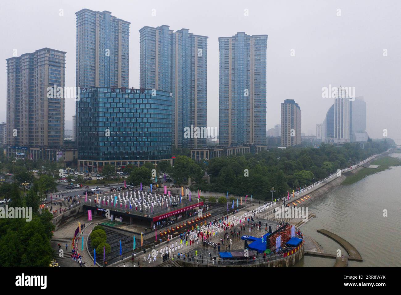 210519 -- TONGLU, May 19, 2021 -- Aerial photo taken on May 19, 2021 shows senior hobbyists of Taijiquan, a traditional Chinese martial art, demonstrating Taijiquan moves by Fuchunjiang River in Tonglu County, east China s Zhejiang Province. A nation-wide campaign to promote and demonstrate Taijiquan as a fitness exercise among senior citizens was launched here on Wednesday. More than 2,000 Taijiquan hobbyists from all over the country flocked in to participate in the demonstrations and performances.  CHINA-ZHEJIANG-TONGLU-TAIJIQUAN FITNESS EXERCISESCN XuxYu PUBLICATIONxNOTxINxCHN Stock Photo