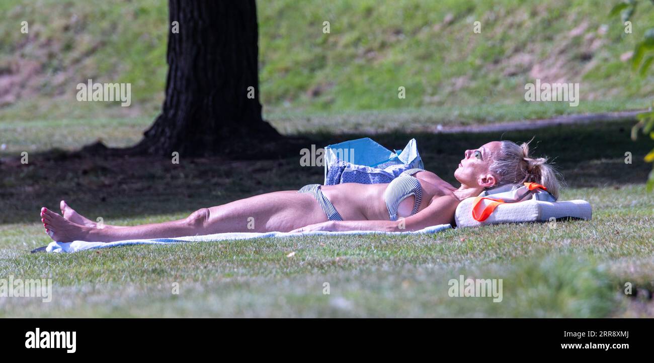 Pic shows: Hot weather in London as temperatures soar into the 30s  Sun goggles for this park sunbather in North London.  supplied by Pixel8000   0791 Stock Photo
