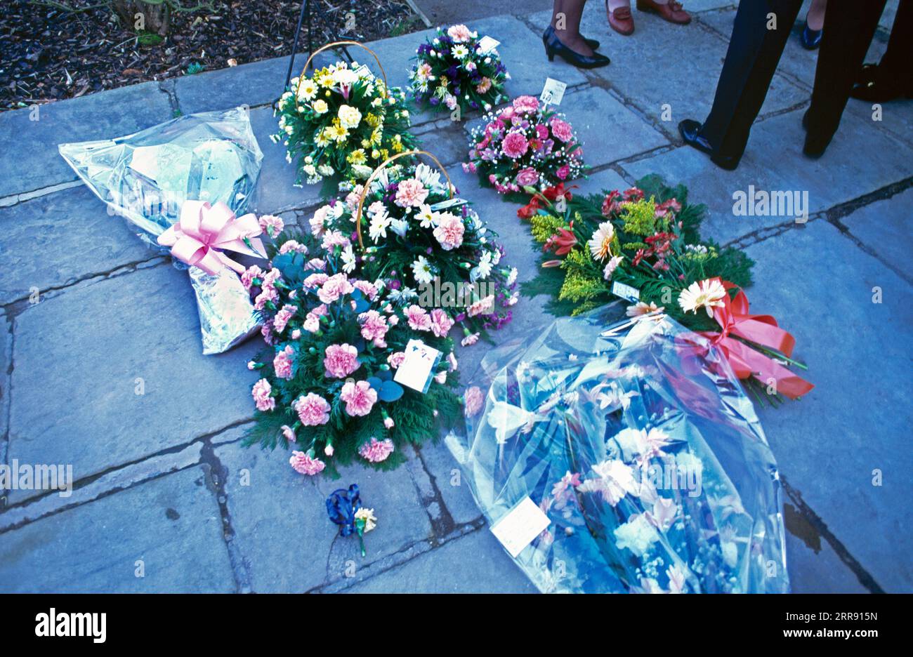 Flower Bouquets on Ground as Remebrance After Cremation Stock Photo