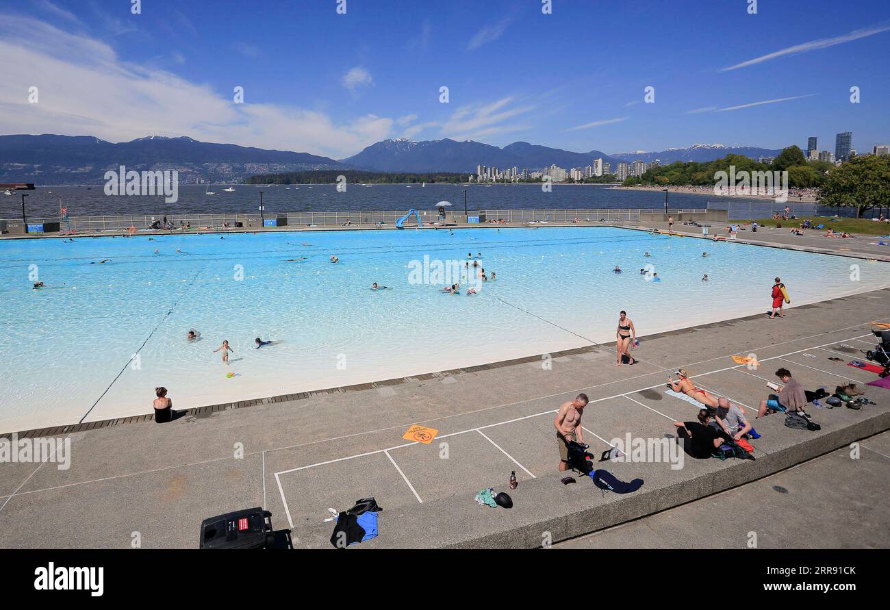 210523 -- VANCOUVER, May 23, 2021 -- People go swimming on the first day of re-opening at the Kitsilano outdoor pool in Vancouver, British Columbia, Canada, May 22, 2021. Three of Vancouver s outdoor pools reopened Saturday. Due to the COVID-19 registration in place, anyone who wants to take a dip will have to register in advance due to pandemic-related restrictions on capacity. Photo by /Xinhua CANADA-VANCOUVER-COVID-19-OUTDOOR POOL-REOPENING LiangxSen PUBLICATIONxNOTxINxCHN Stock Photo