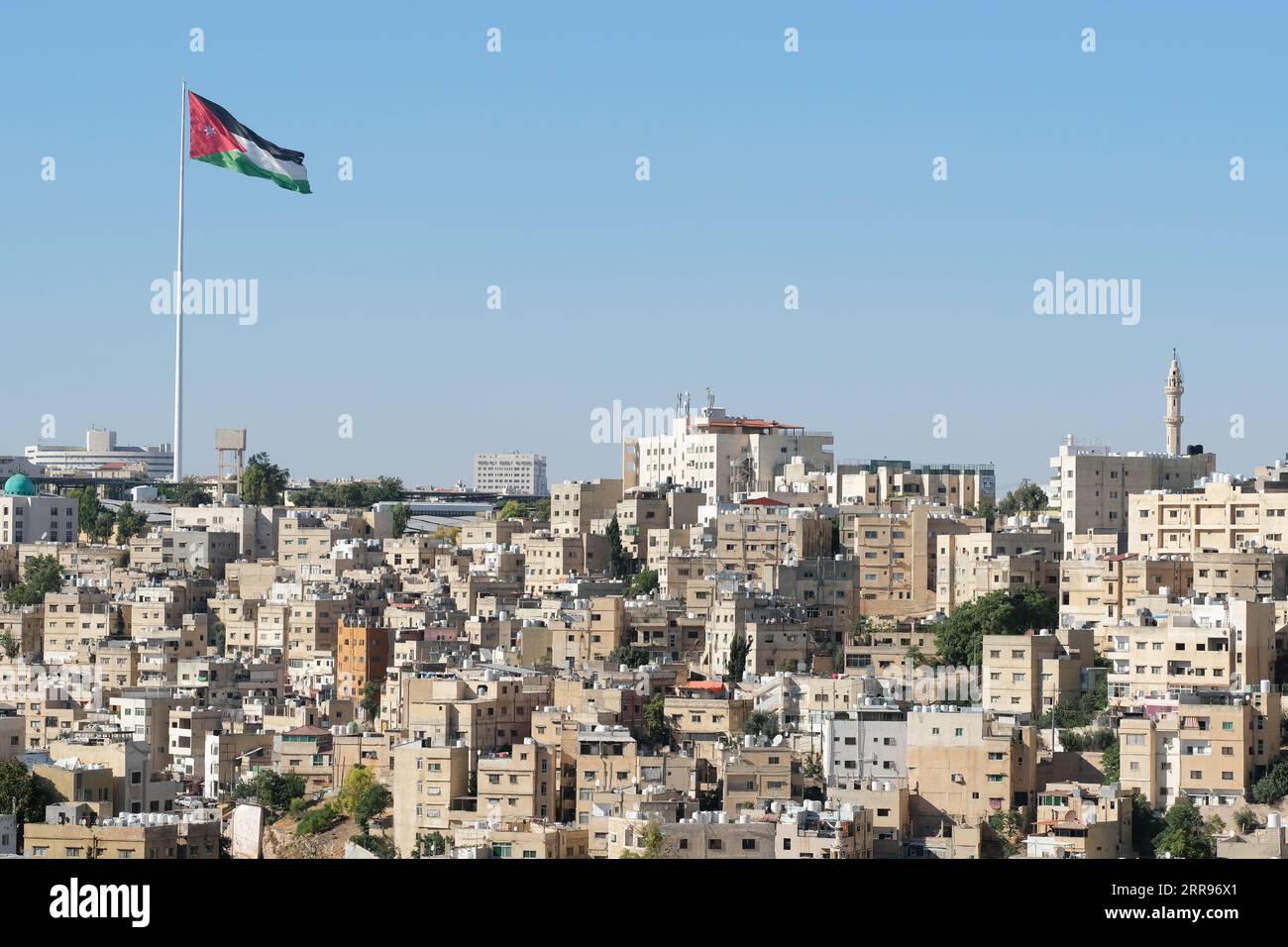 Amman Jordan large Jordanian national flag flying over the residential