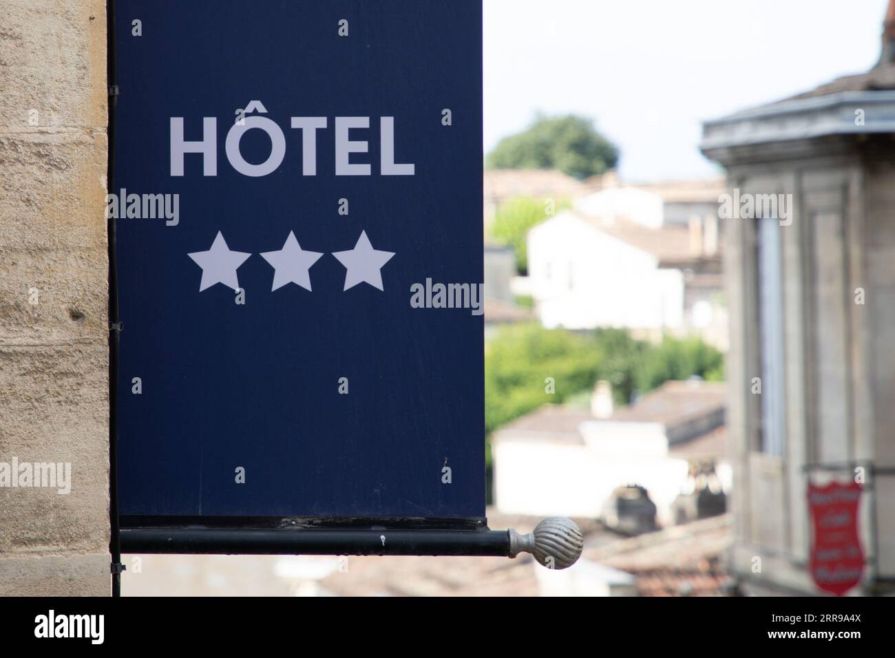 Hotel three stars flag sign text on flag wall building facade in tourist city Stock Photo