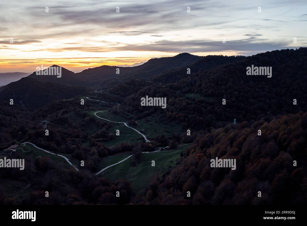 Aerial view of a road winding through forest hi-res stock photography ...