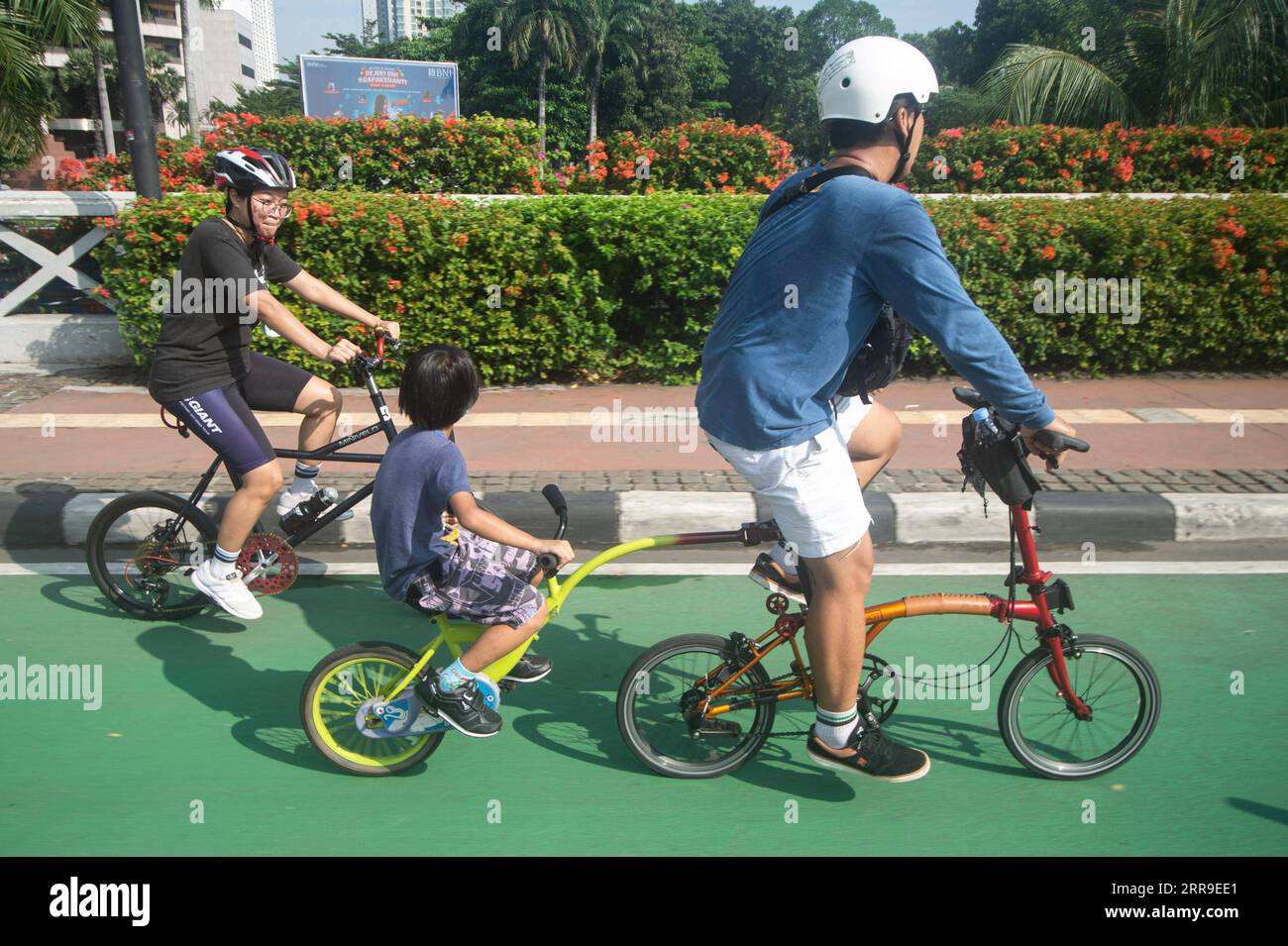 210613 JAKARTA, June 13, 2021 Cyclists ride along a bike lane on