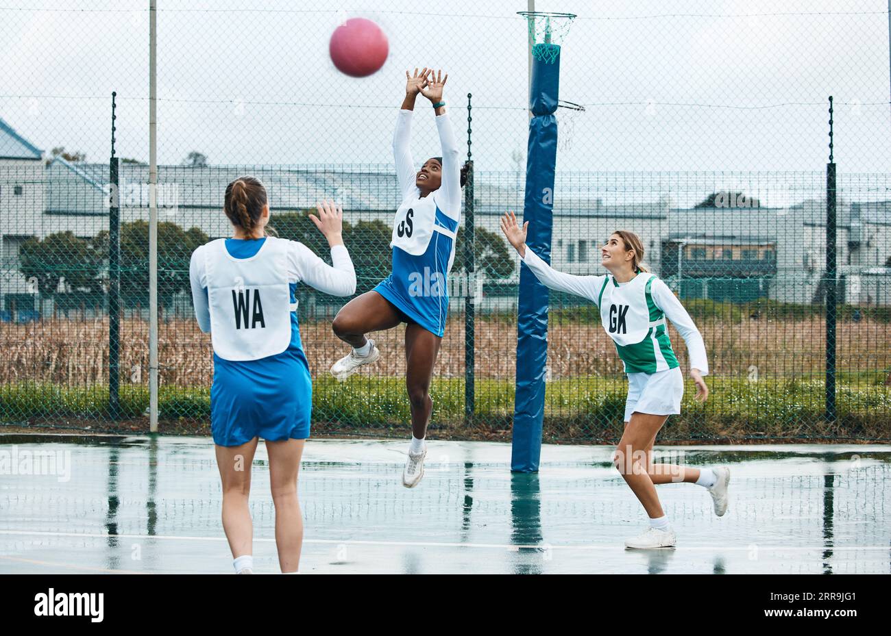Netball, sports team and woman jump for ball, practice and playing game, court challenge or high school match. Fitness, teamwork and group workout Stock Photo
