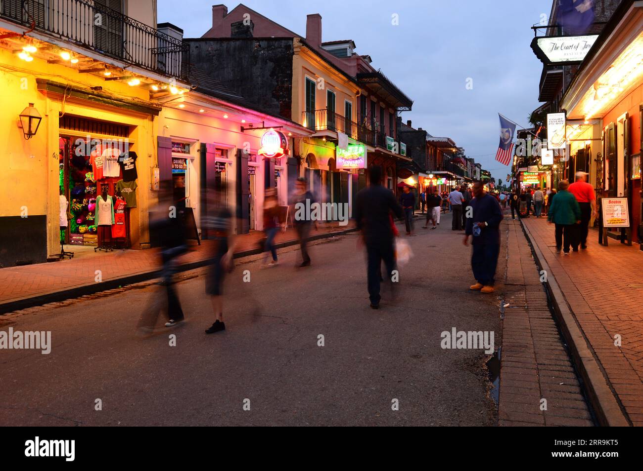 Dusk settles on Bourbon Street in the French Quarter of New Orleans inviting revelers to drink and eat at the area's bars, taverns and restaurants Stock Photo