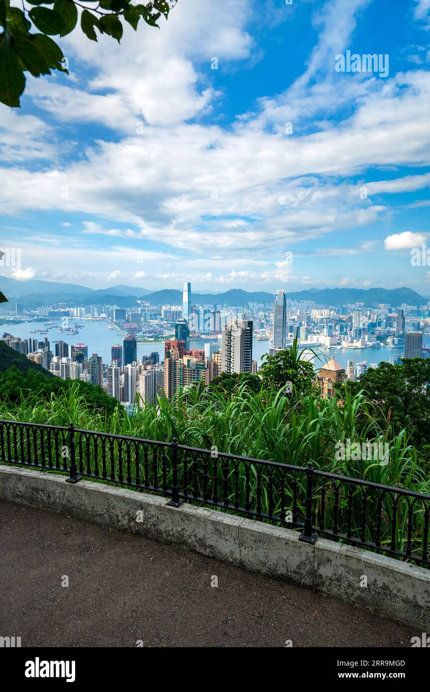 Landmark view of Hong Kong island downtown modern cityscape on a blue sky daytime seen from the Victoria peak rising high above the Special Administra Stock Photo