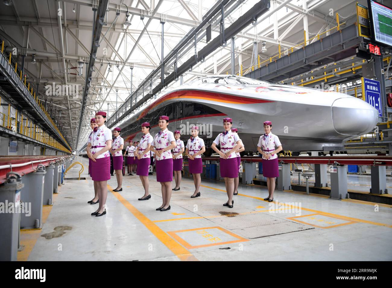 210623 -- CHONGQING, June 23, 2021 -- Crew members pose for photos with a CR400AF Fuxing intelligent bullet train in southwest China s Chongqing, June 23, 2021. The CR400AF Fuxing intelligent bullet train will be put into service on the railway linking Chengdu, capital city of southwest China s Sichuang Province, and Chongqing on Friday.  CHINA-CHONGQING-INTELLIGENT BULLET TRAIN CN TangxYi PUBLICATIONxNOTxINxCHN Stock Photo