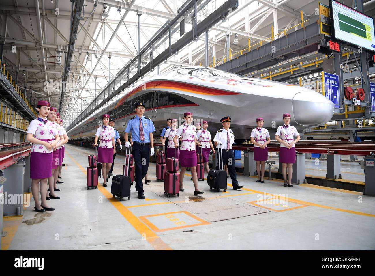 210623 -- CHONGQING, June 23, 2021 -- Crew members pose for photos with a CR400AF Fuxing intelligent bullet train in southwest China s Chongqing, June 23, 2021. The CR400AF Fuxing intelligent bullet train will be put into service on the railway linking Chengdu, capital city of southwest China s Sichuang Province, and Chongqing on Friday.  CHINA-CHONGQING-INTELLIGENT BULLET TRAIN CN TangxYi PUBLICATIONxNOTxINxCHN Stock Photo