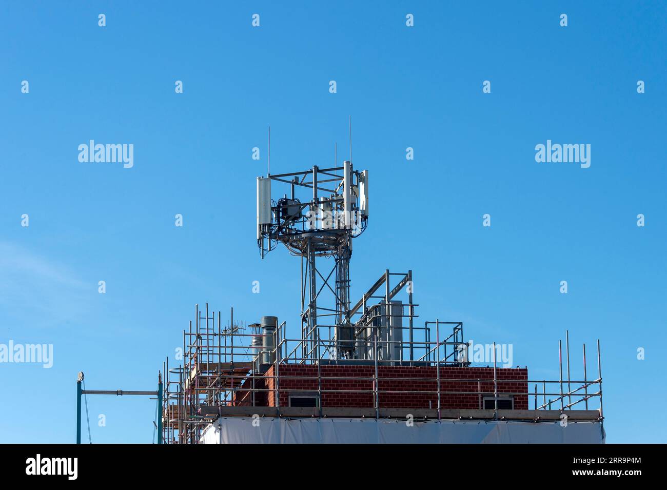 Lots of telcommunication antennas on the roof of a building Stock Photo