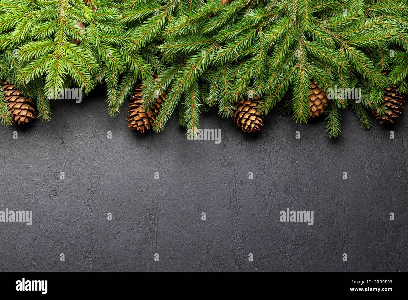 Christmas fir tree branch frame over stone with space for greetings ...