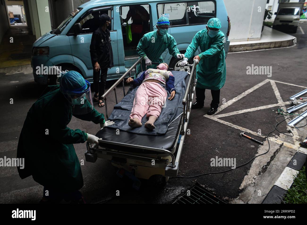 210627 -- JAKARTA, June 27, 2021 -- Health workers transfer a patient with high fever in Jakarta, Indonesia, on June 24, 2021. The Health Ministry said on June 26, 2021 that the country recorded 21,095 new COVID-19 cases in the past 24 hours, the highest daily spike since March last year when the first COVID-19 case was detected in the country, bringing the total national tally to 2,093,962.  INDONESIA-JAKARTA-COVID-19 PATIENT AgungxKuncahyaxB. PUBLICATIONxNOTxINxCHN Stock Photo