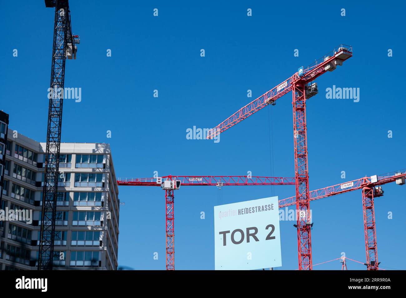 06.09.2023, Berlin, Germany, Europe - Construction cranes rise into the blue sky at a Europacity building site in the new Heidestrasse urban quarter. Stock Photo