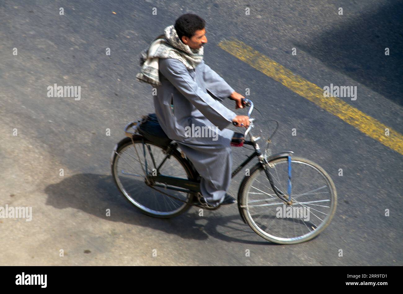 Luxor Egypt Man Riding Bicycle. Stock Photo