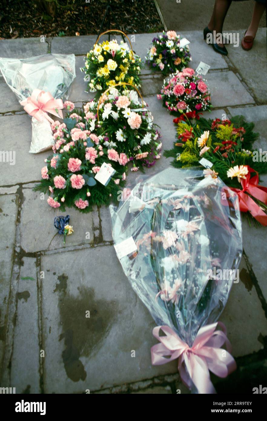 Flower Bouquets on Ground as Remebrance After Cremation Stock Photo