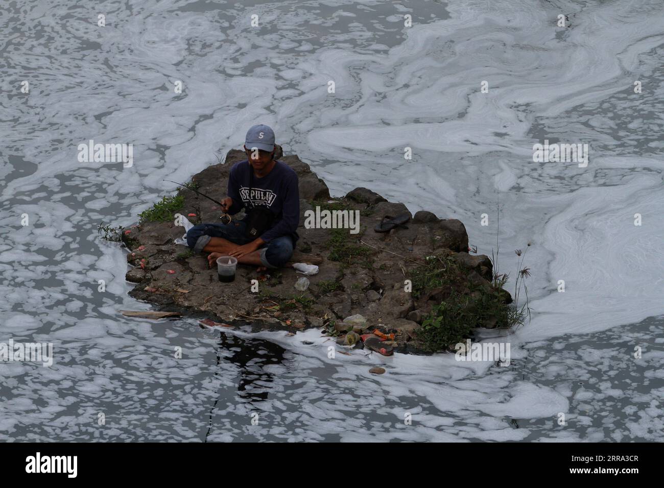September 7, 2023, Yogyakarta, Special Region of Yogyakarta, Indonesia: A man fishes in the foamy water of the Gajahwong River. (Credit Image: © Angga Budhiyanto/ZUMA Press Wire) EDITORIAL USAGE ONLY! Not for Commercial USAGE! Stock Photo