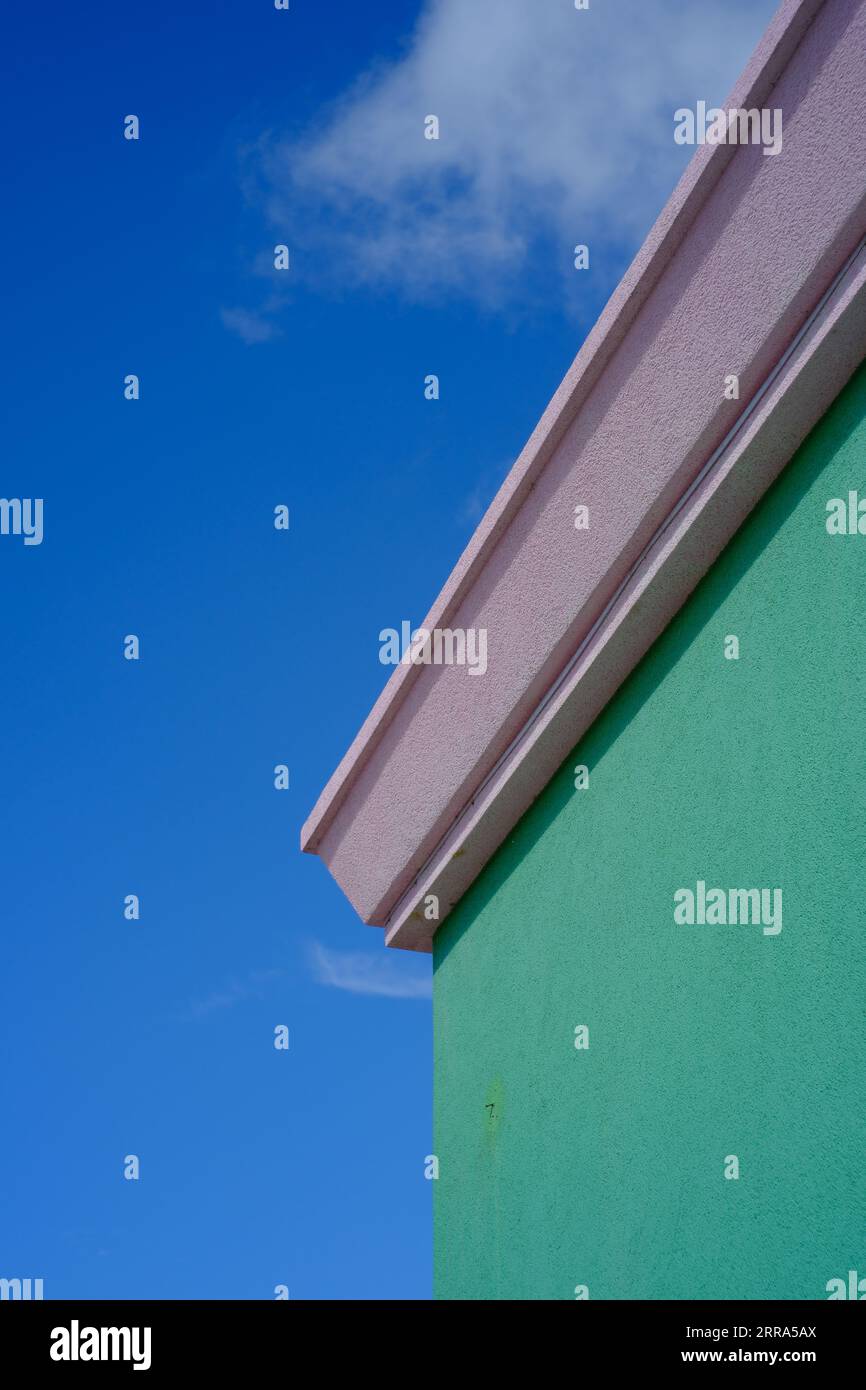Corner of a green building against a blue sky Stock Photo