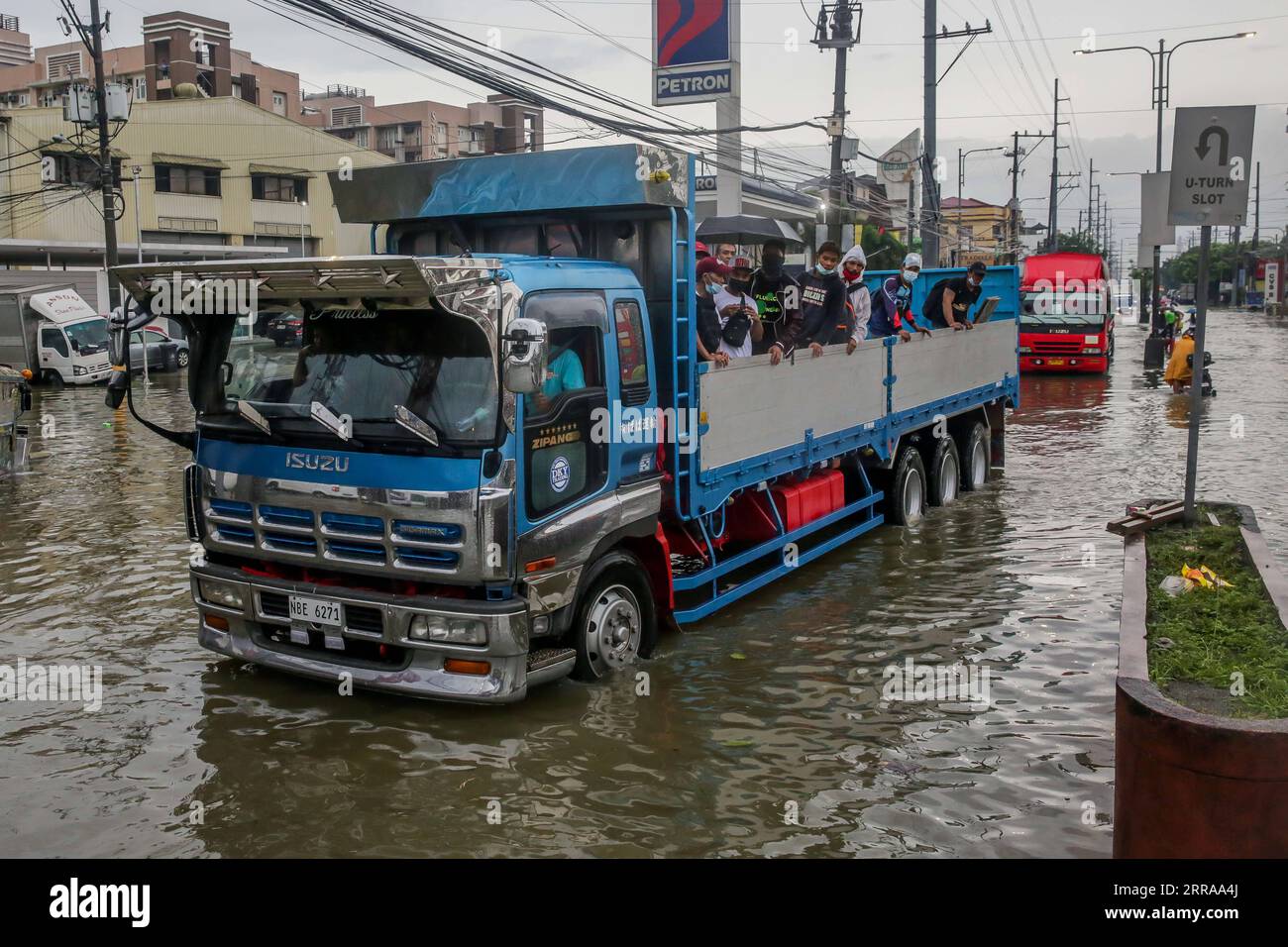 210724 -- RIZAL PROVINCE, July 24, 2021 -- People are seen on a truck to avoid the flood brought by heavy monsoon rains in Rizal Province, the Philippines, July 24, 2021. The Philippines have evacuated more than 15,000 people in Metro Manila and some parts of the country amid flood threat, disaster management authorities said on Saturday.  PHILIPPINES-RIZAL PROVINCE-MONSOON FLOODS RouellexUmali PUBLICATIONxNOTxINxCHN Stock Photo