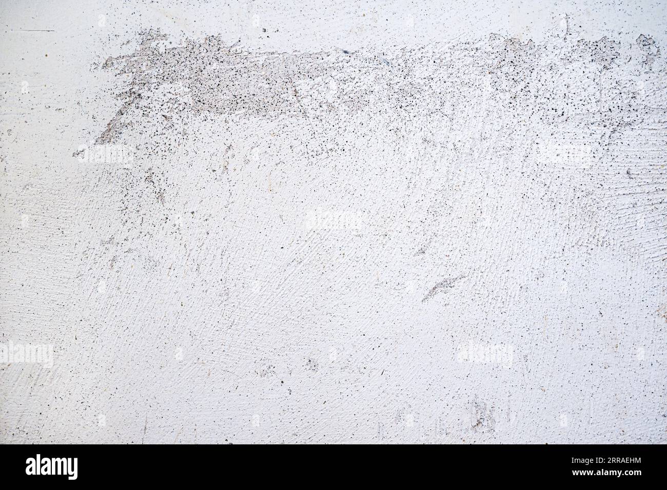 Plastered wall surface with rubbed off white paint, light gray background texture for urban themes or architecture, full frame, copy space Stock Photo