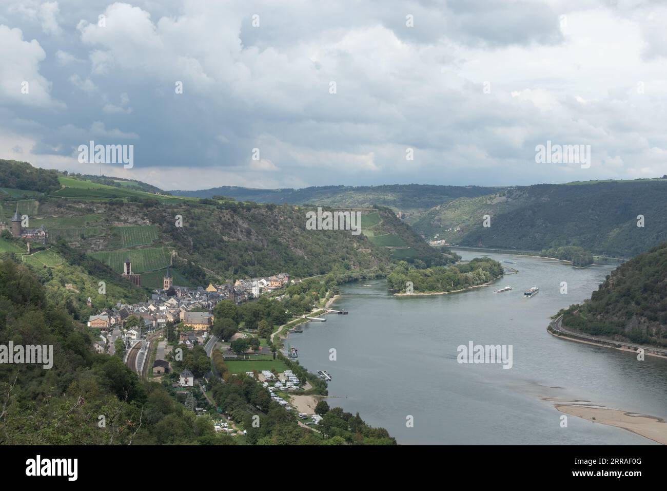 Commercial barges and other river traffic proceed along the River Rhine in the Mainz-Bingen area, Germany Stock Photo