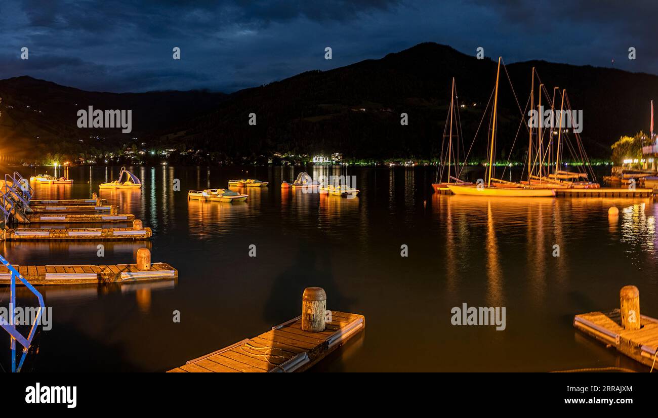 lightened boats and landing stages on the Lake Zeller at night in the region Salzburg, Austria Stock Photo