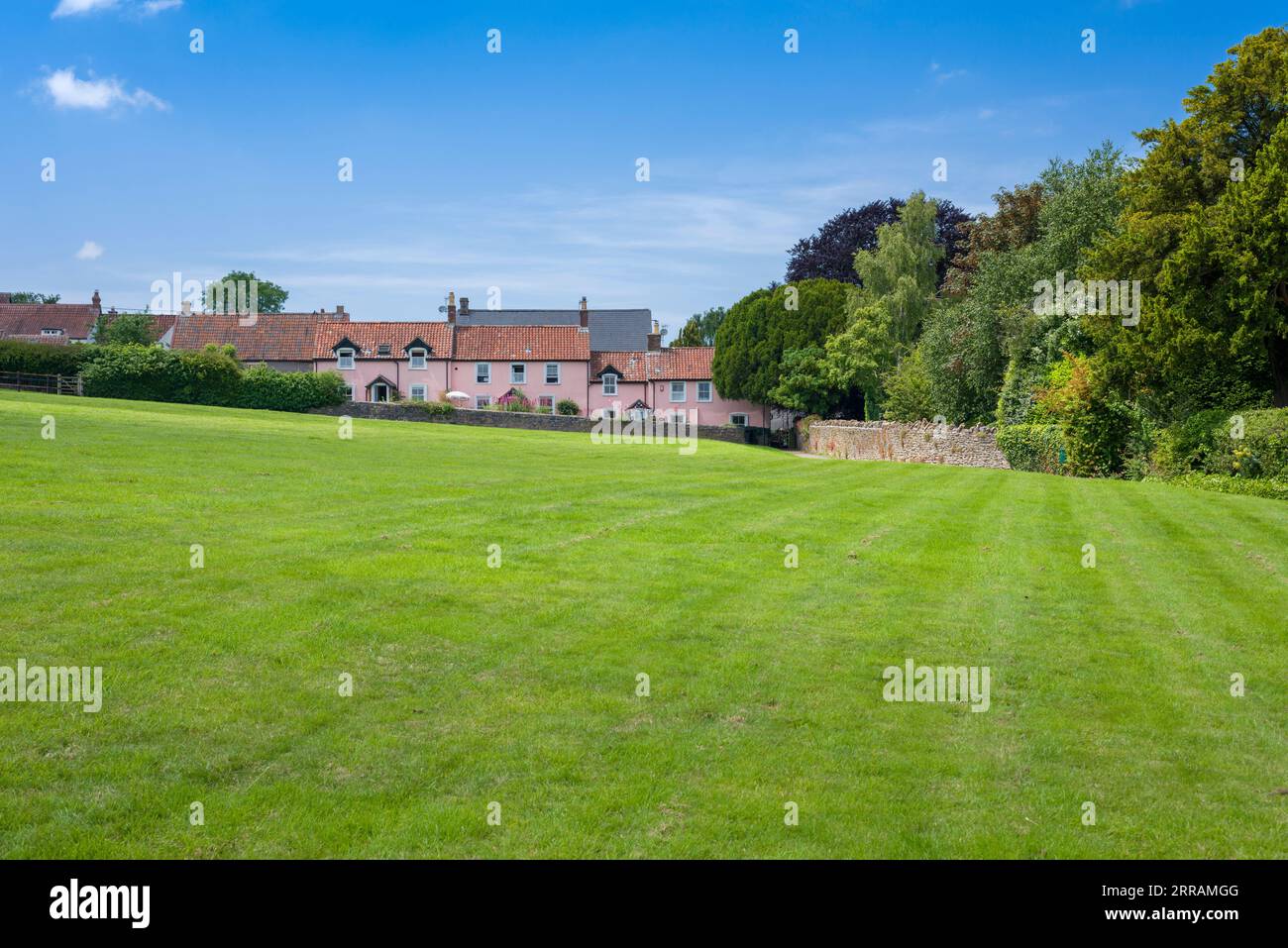 Cottages overlooking the village green in Blagdon in the Mendip Hills North Devon Coast National Landscape, North Somerset, England. Stock Photo