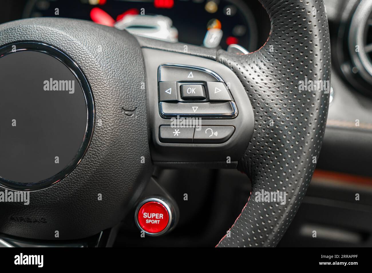 Enhance your driving experience with our steering wheel featuring multi-function buttons for easy access to audio, phone, and cruise control functions Stock Photo