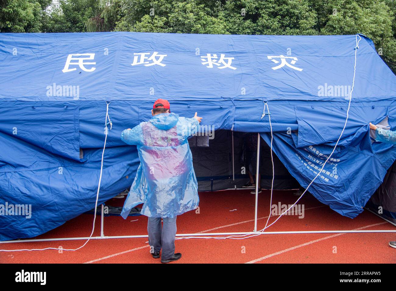 210813 -- SUIZHOU, Aug. 13, 2021 -- A rescuer puts up a tent in Liulin Township of Suixian County, central China s Hubei Province, Aug. 13, 2021. Twenty-one people were killed and four others missing as heavy rain lashed Liulin Township from Wednesday to Thursday, local authorities said Friday. The Liulin Township saw total precipitation reaching 503 mm from 9 p.m. Wednesday to 9 a.m. Thursday, causing an average waterlogging depth of 3.5 meters, the county said in an announcement. Over 8,000 people have been affected in the township, according to the announcement. Disaster relief and rescue e Stock Photo