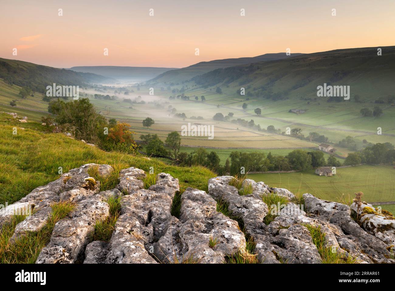 A misty morning view in the Yorkshire Dales, looking up the valley of Upper-Wharfedale. Image taken above Kettlewell, looking towards Buckden Stock Photo